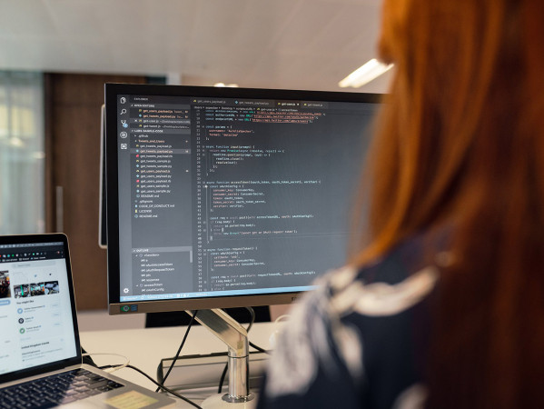 person writing code on a computer