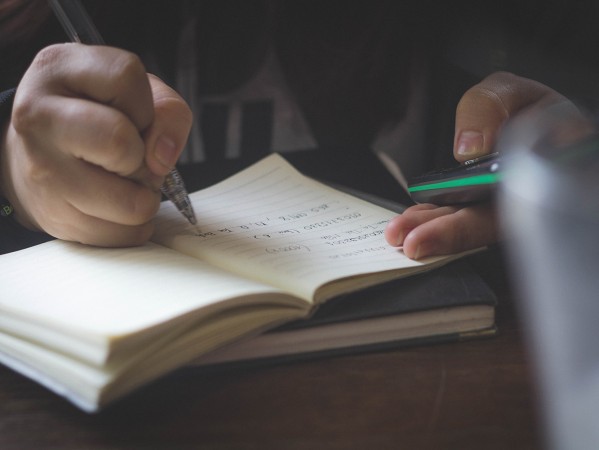 person writing in a notebook