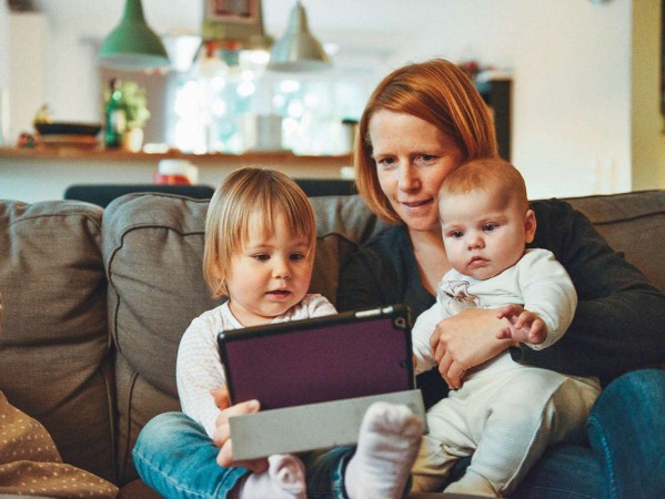 Mum reading with two children Mum reading with two children