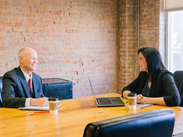 man and a woman at a meeting table man and a woman at a meeting table