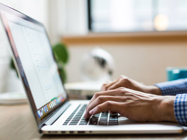 person typing on a laptop