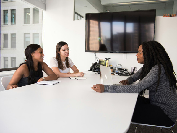 Three women meeting around a table