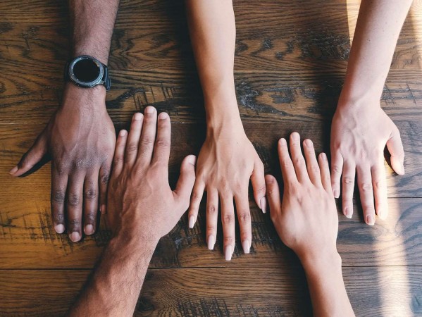 diverse collection of hands on a table