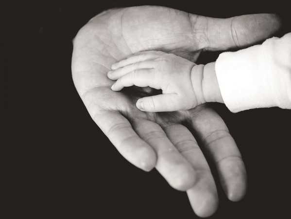 baby's hand in an adult's hand