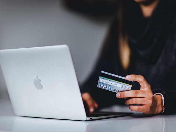 person with a laptop and credit card person with a laptop and credit card