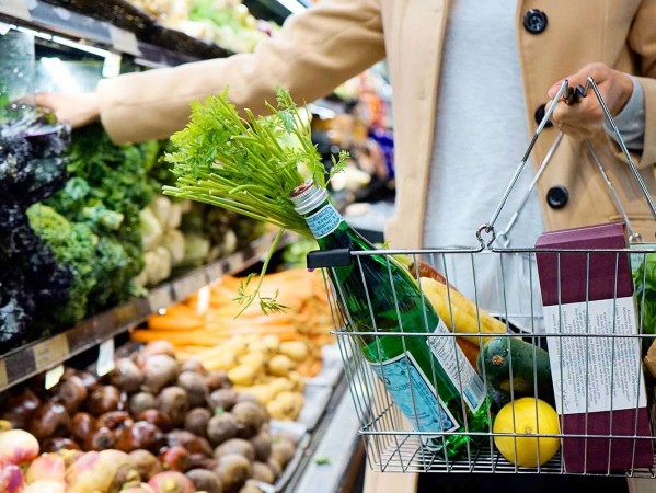 woman at a grocery shop holding a basket