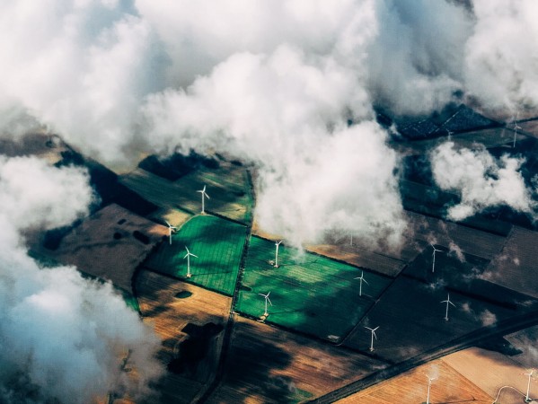 aerial image of green fields with wind turbines