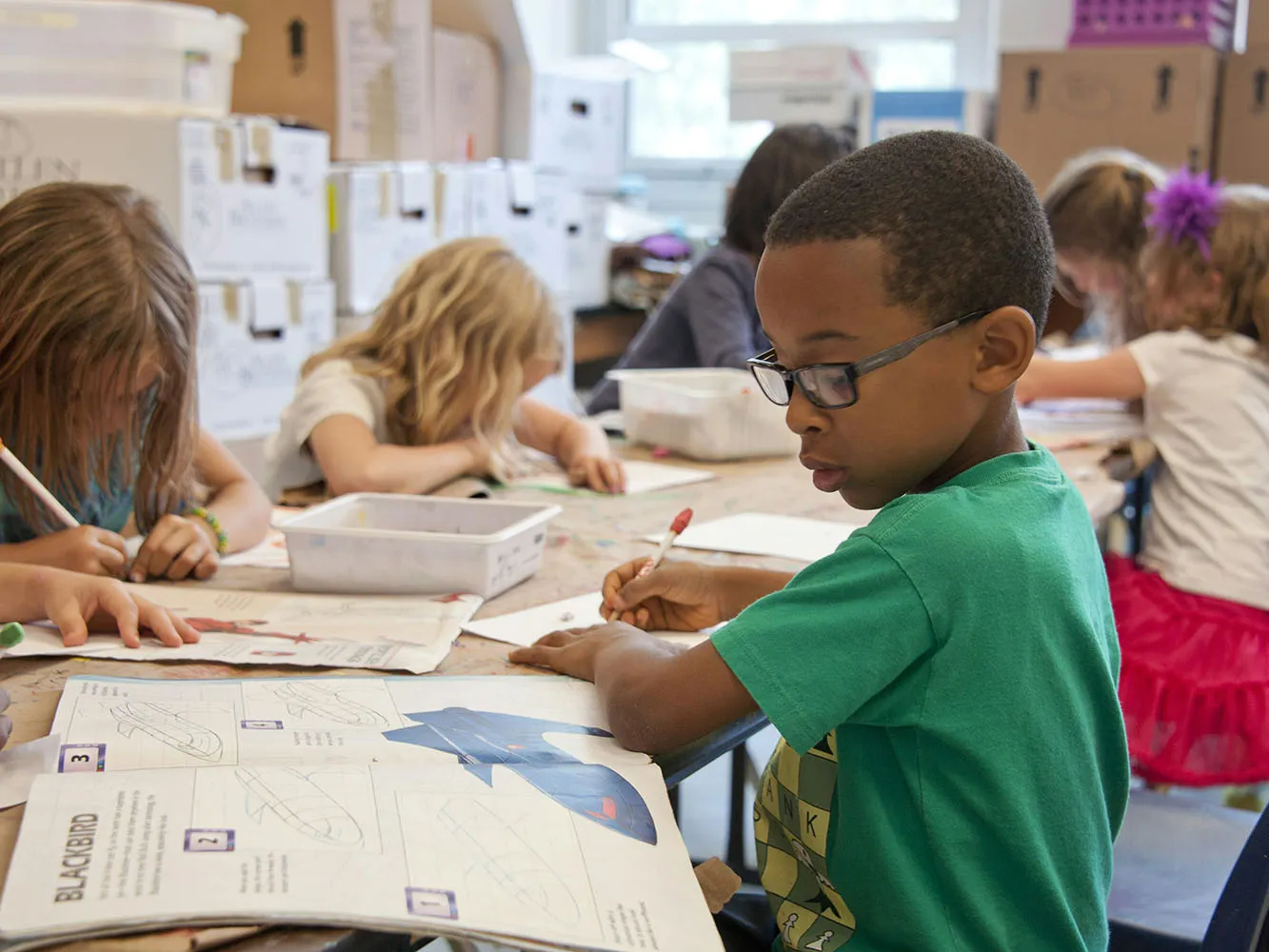 children working on paper at school